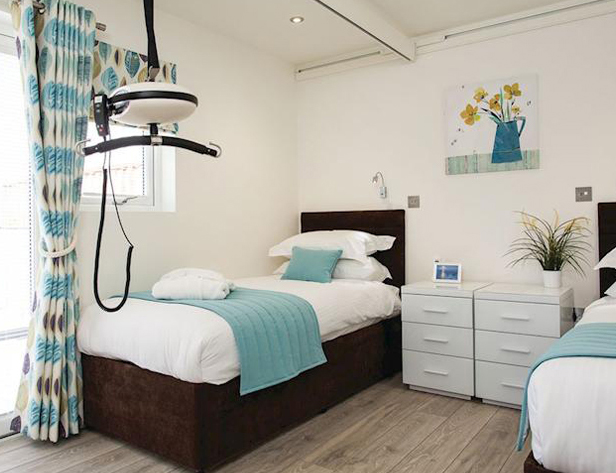 Ceiling track hoist in a disabled-friendly bedroom