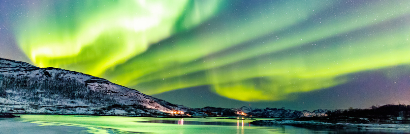 The Northern Lights above a frozen lake in Norway